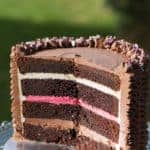{Devil's food cake filled with Neapolitan buttercream - Italian meringue buttercream flavoured with vanilla, chocolate and freeze-dried strawberry powder}