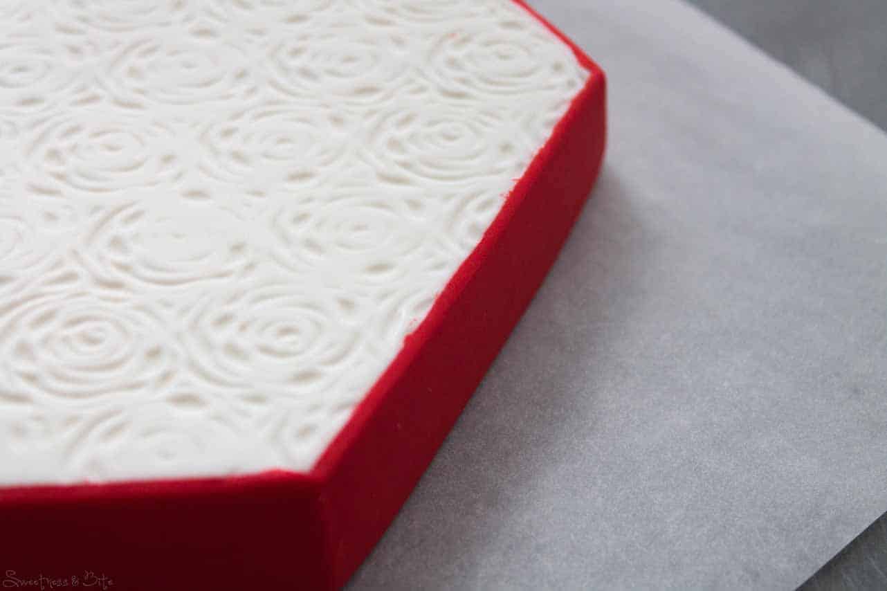 These rough bits of fondant are easily scratched off with a scalpel or razor blade once the fondant is dry.