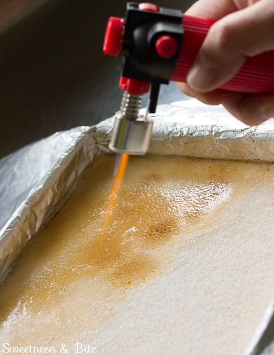 Caramelising the sugar on top of the fudge using a small culinary torch.