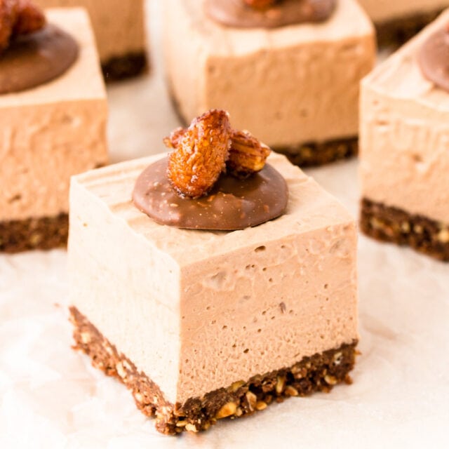 Squares of Toblerone cheesecake, topped with discs of melted Toblerone and honey roasted almonds.