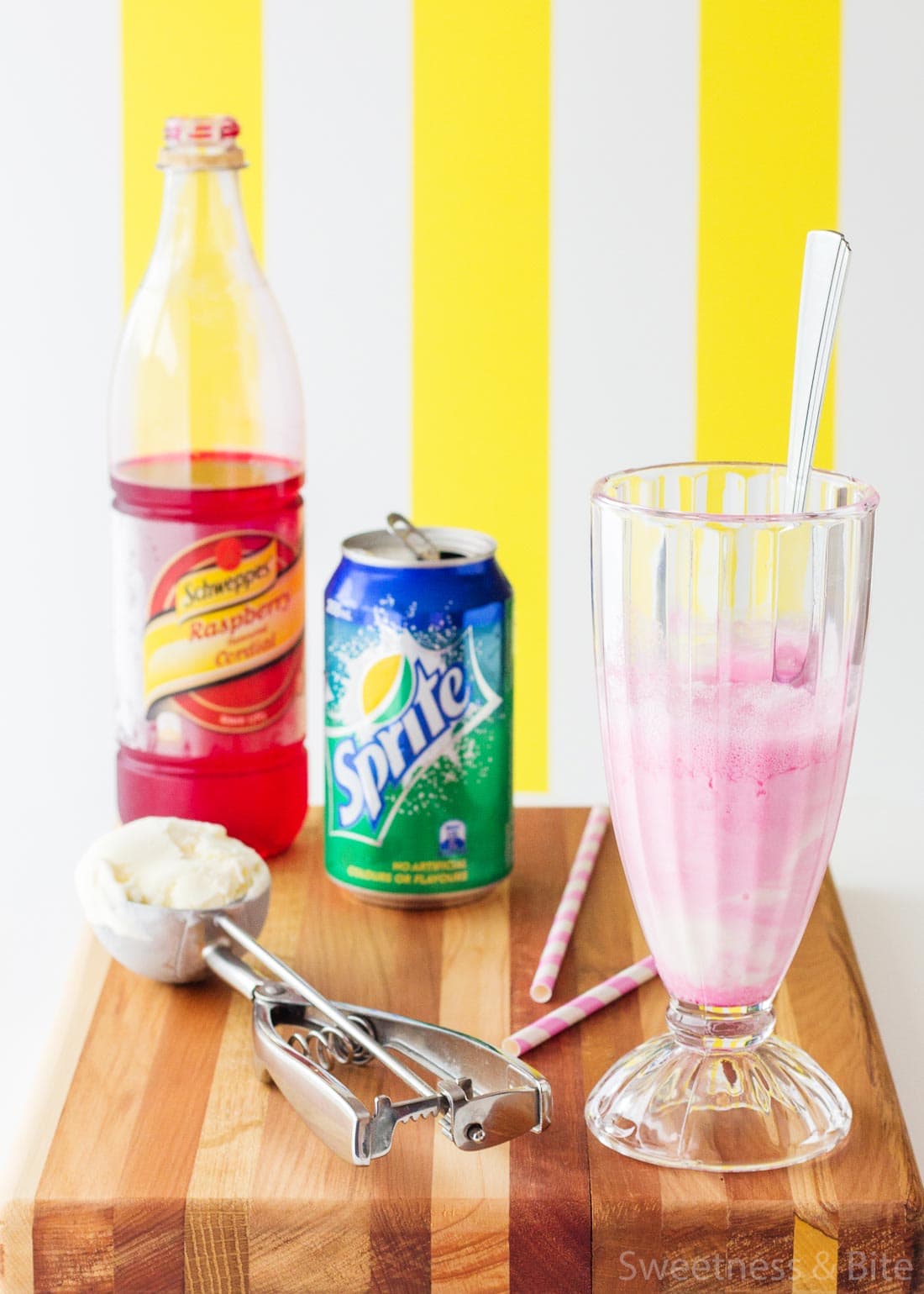 A tall glass with ice cream and cordial mixed together.