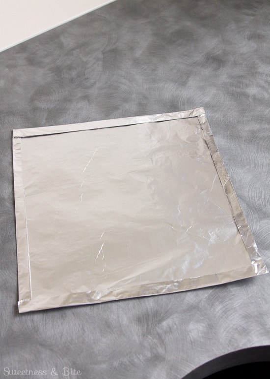 A square sheet of foil with the edges folded over.