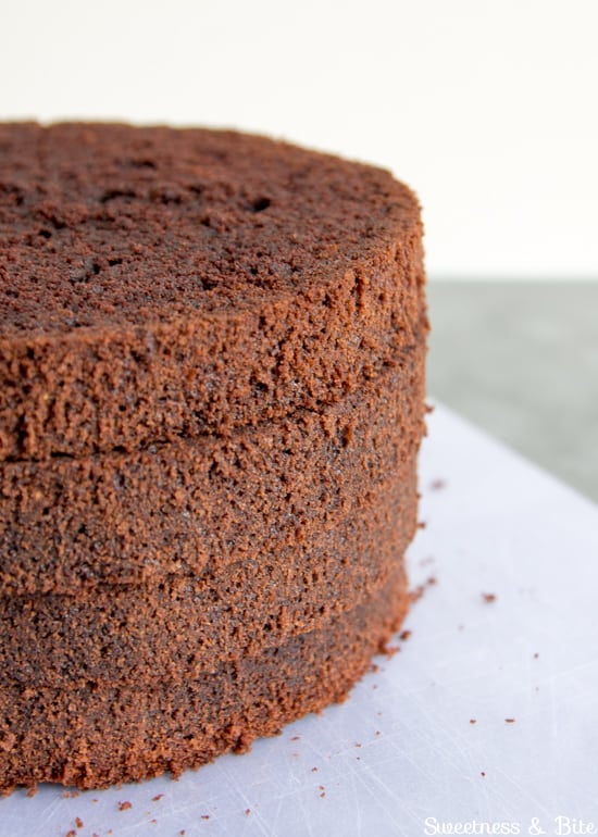 Four stacked layers of chocolate cake.