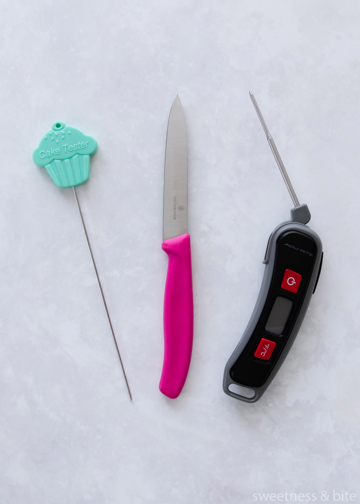 A cake testing skewer, a thin-bladed knife and a probe thermometer.