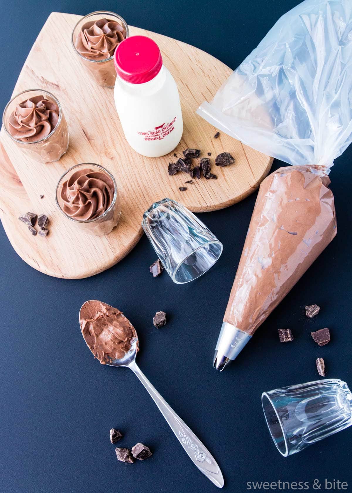 Piping the easy chocolate mousse into small glasses.