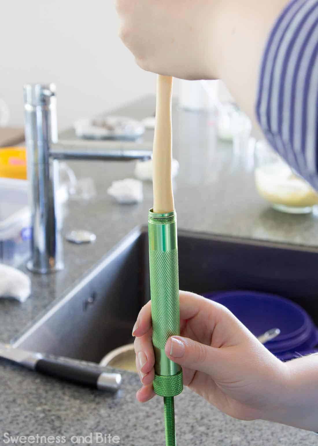 The fondant/modelling choc being loaded into the clay extruder.