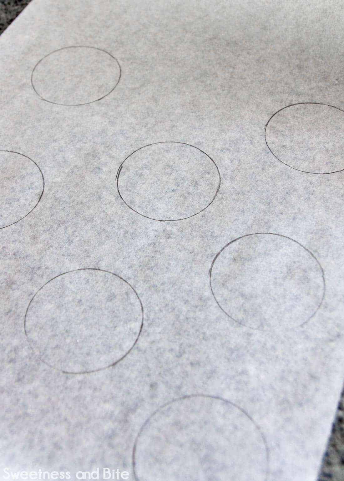 Circles drawn onto a sheet of non-stick baking paper.