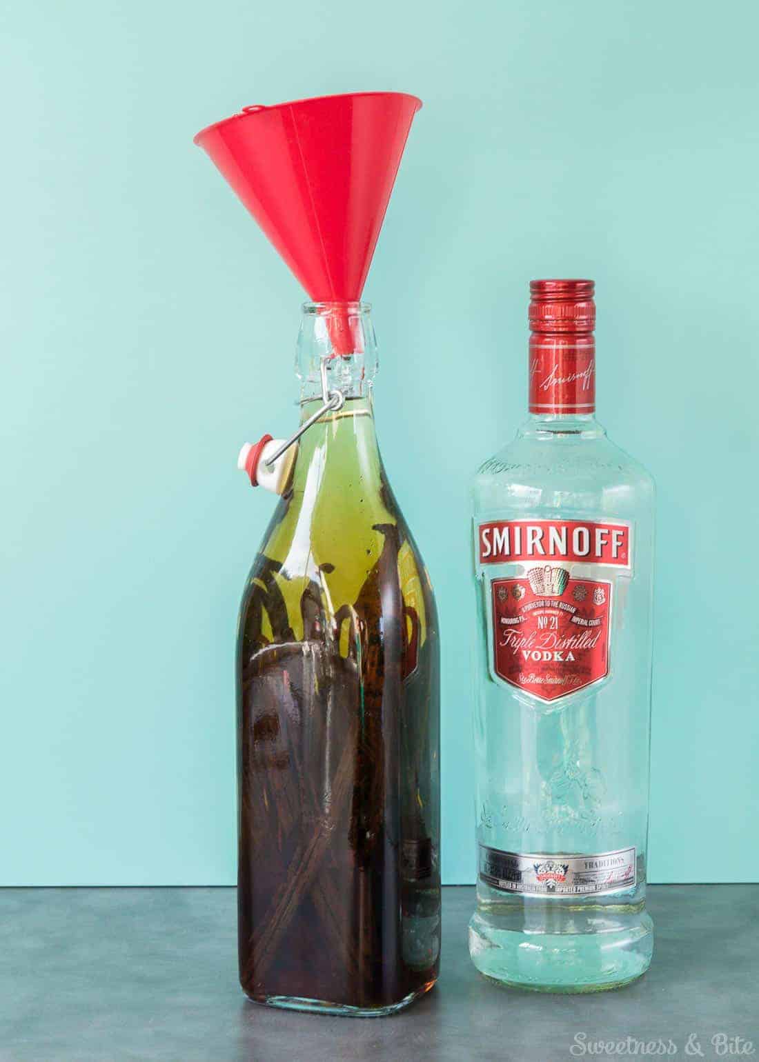 The bottle with vanilla beans, rum and vodka poured in to the top.