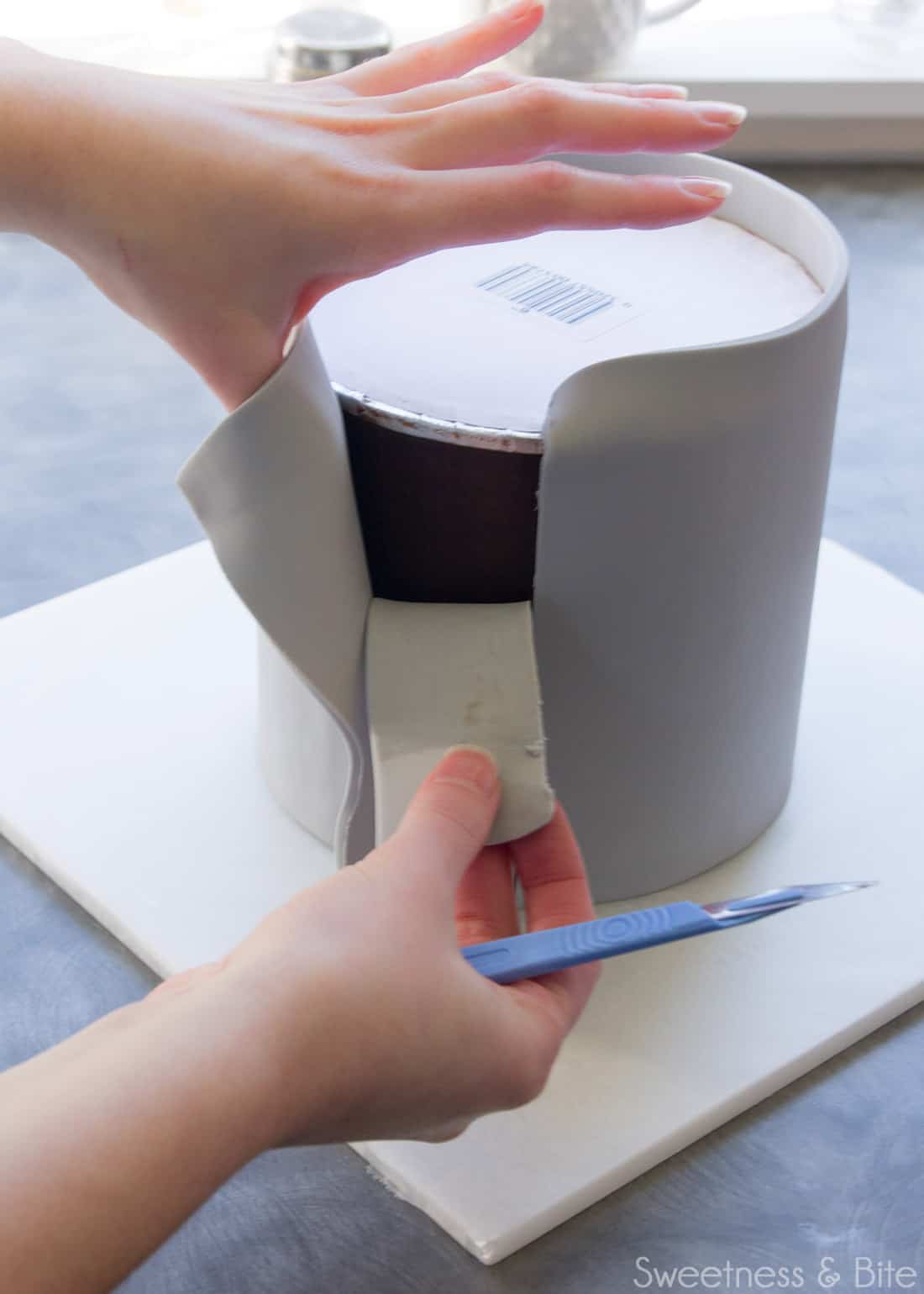 The inner off-cut being peeled away from the cake and removed.