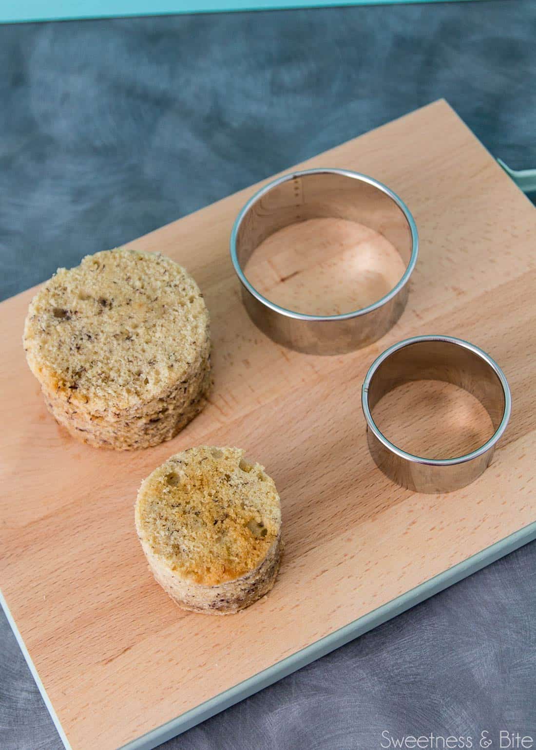 Two round pieces of banana cake, cut out with cookie cutters.