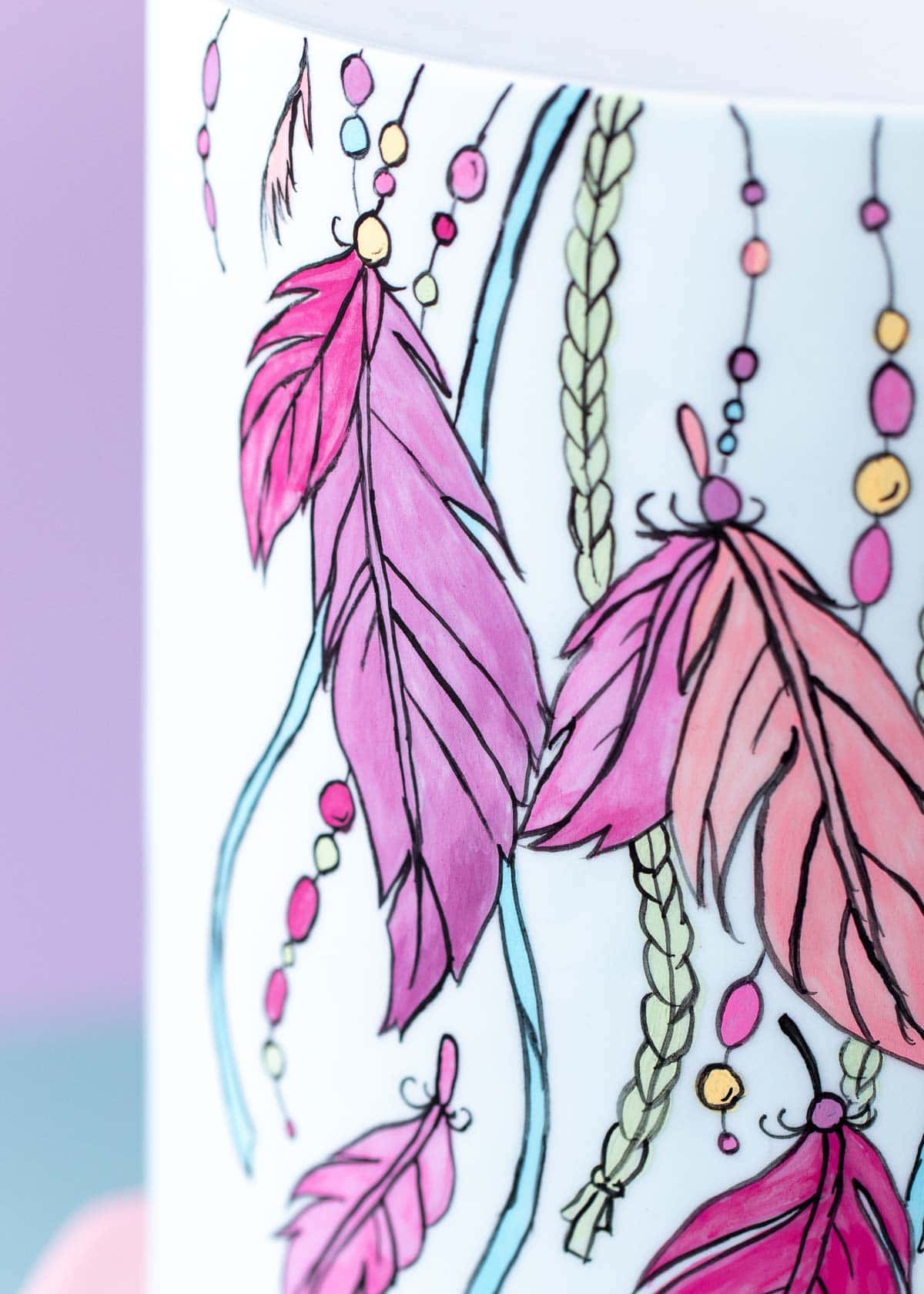 Close up image of the painted and outlined design around front of the cake.