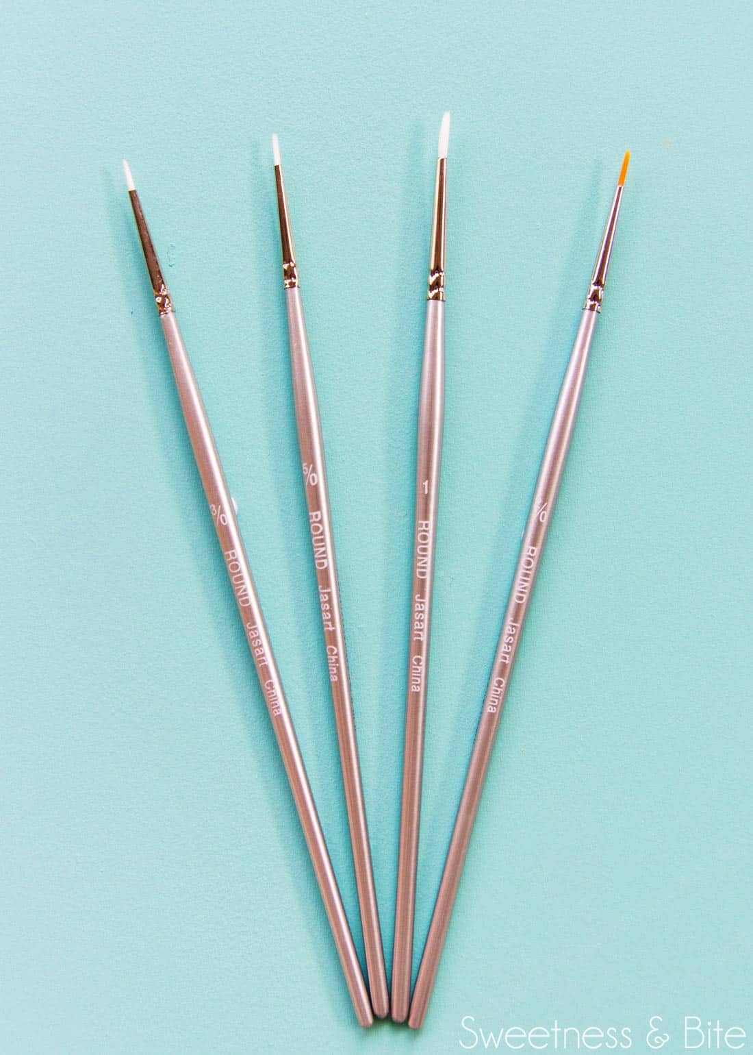Fine paintbrushes for painting on a cake.