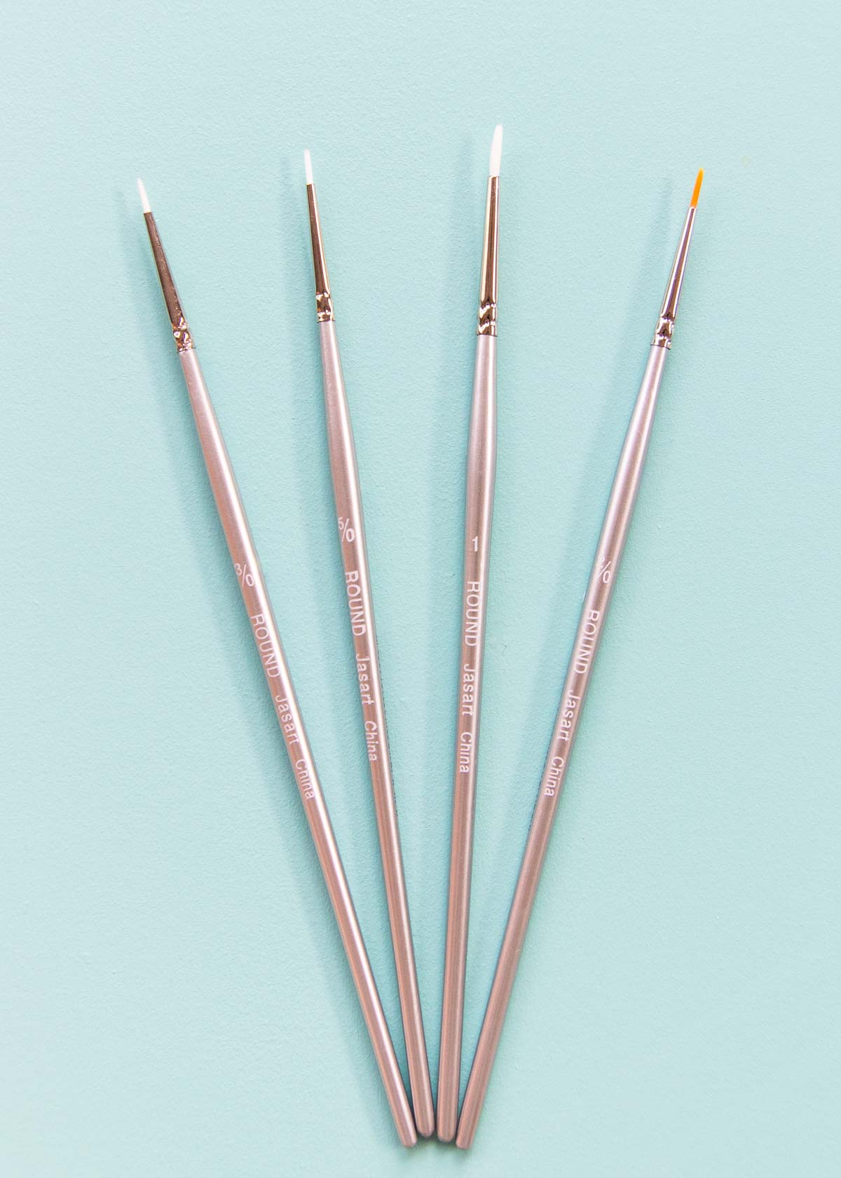 Fine paintbrushes for painting on a cake.