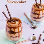 Individual cheesecakes in stemlesswine glasses - text overlay reads 