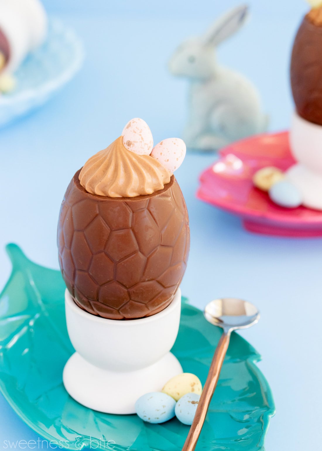 Close up of a chocolate egg filled with mousse, decorated with Cadbury mini eggs.