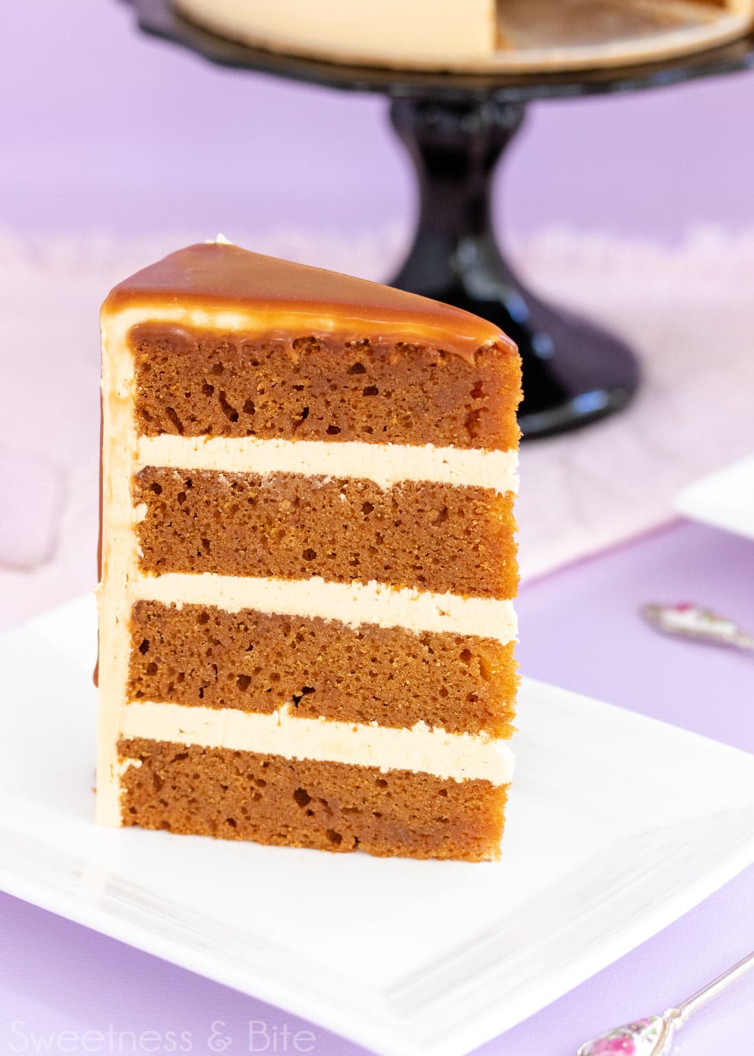 Close up of a slice of caramel mud cake with three layers of caramel buttercream.