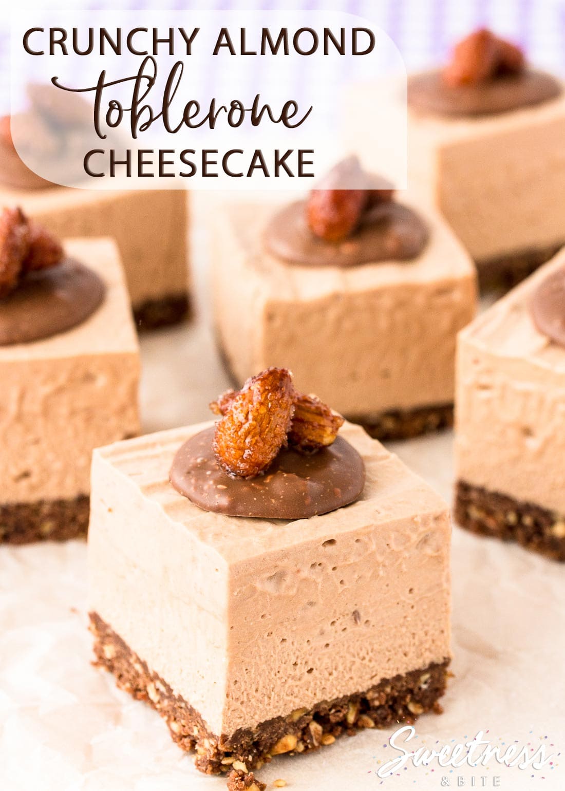 Square pieces of Toblerone cheesecake on crinkled parchment paper.
