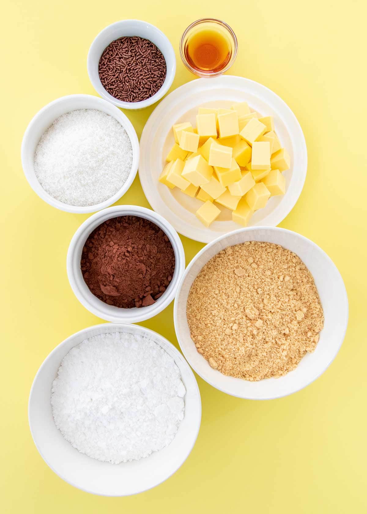 Chocolate coconut truffle ingredients - crushed cookies, icing sugar, butter, cocoa, coconut, vanilla and sprinkles