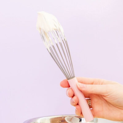 sweetened whipped cream on a whisk