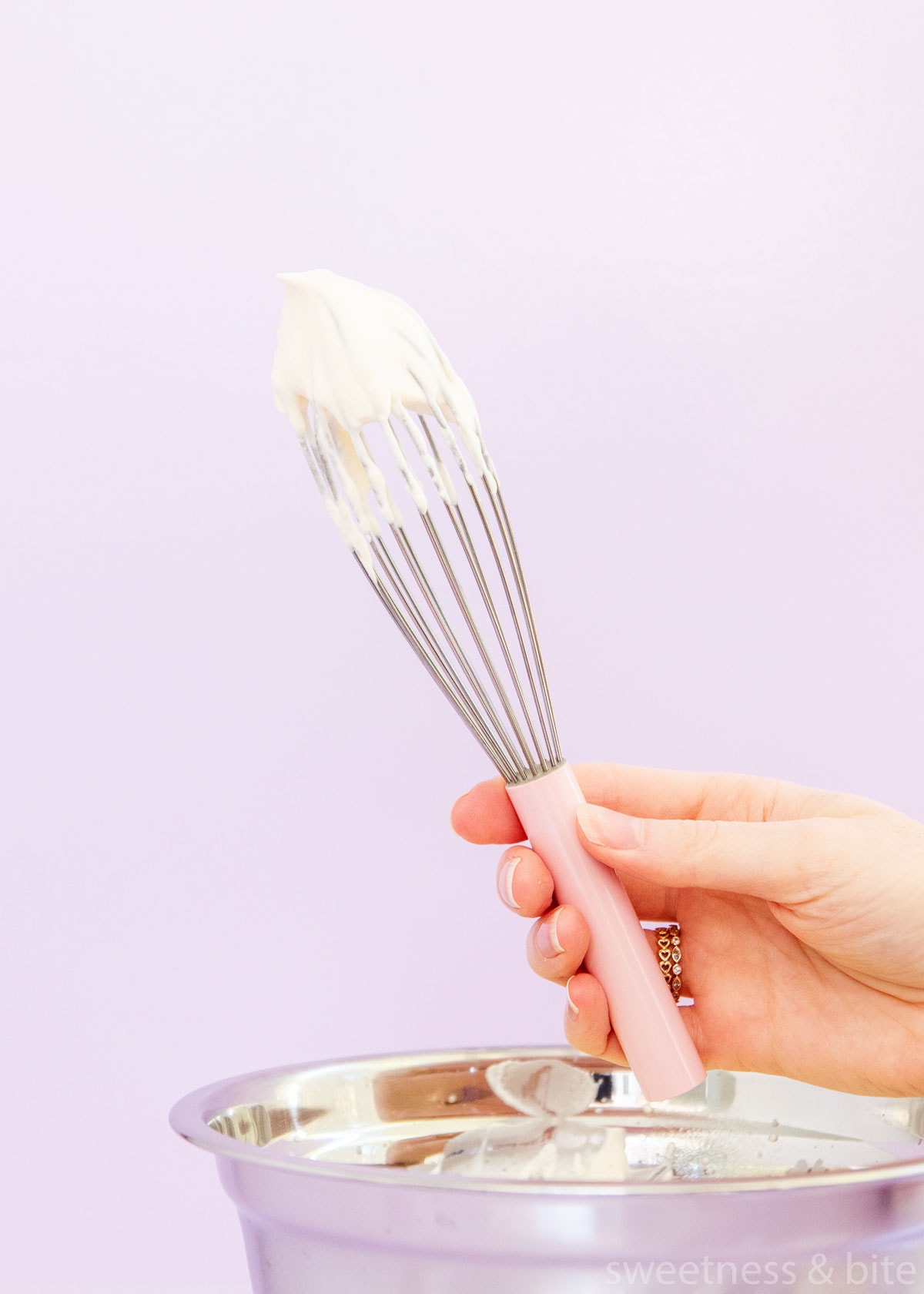 sweetened whipped cream on a whisk