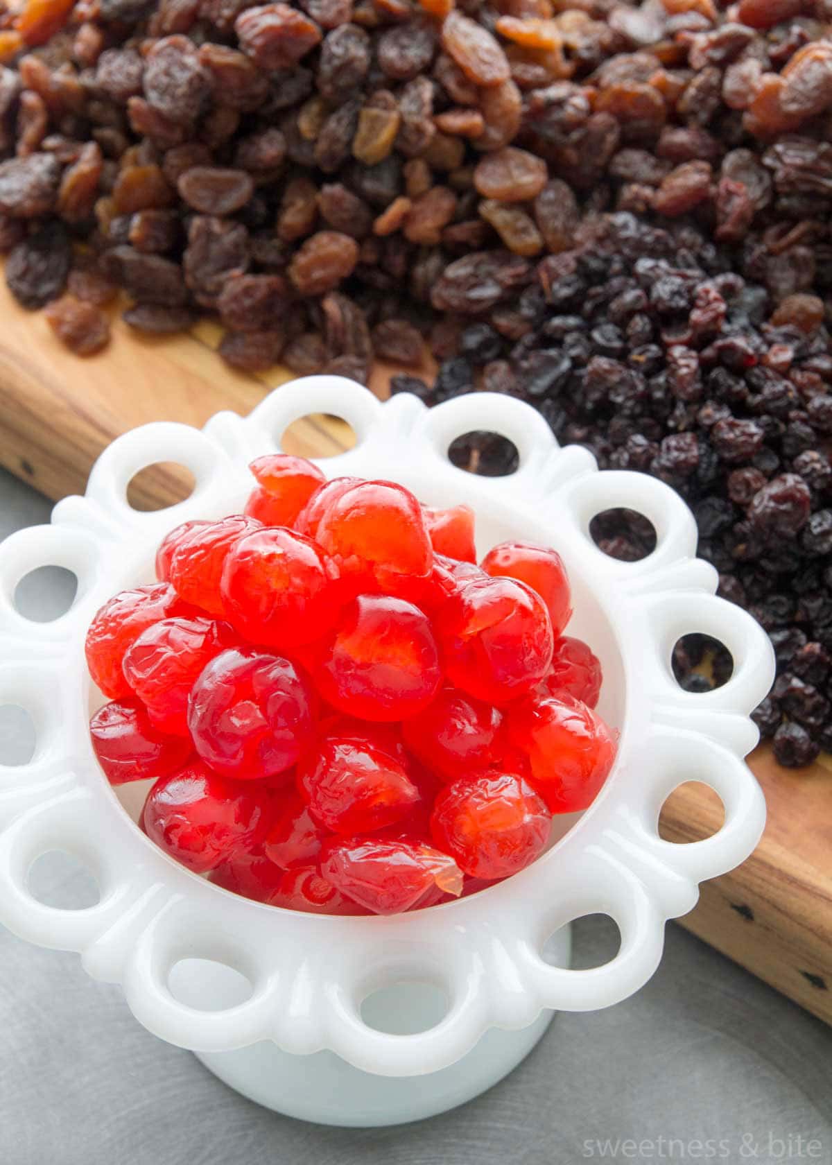 A white bowl of red glacé cherries.