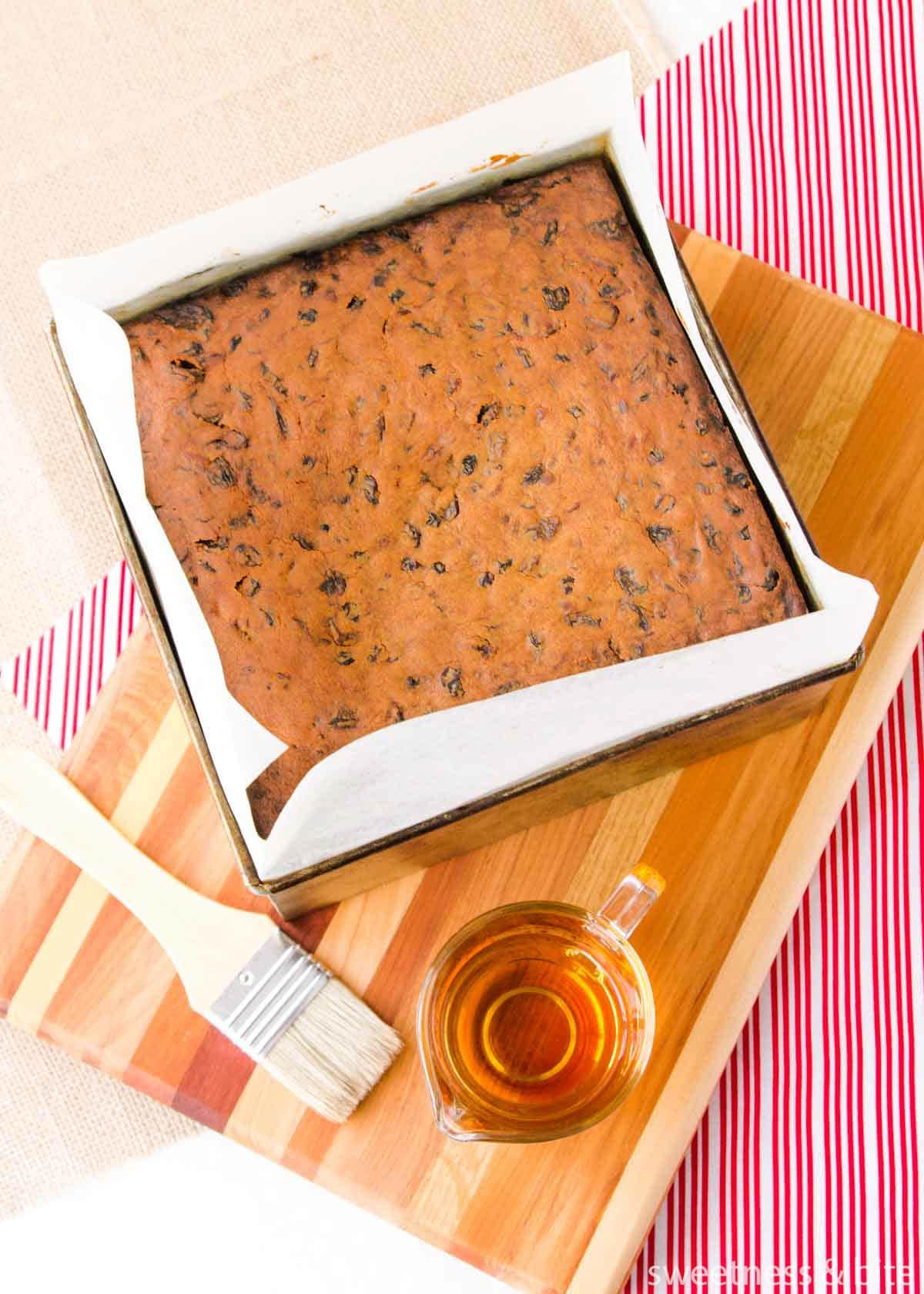 Baked fruit cake about to be brushed with brandy.