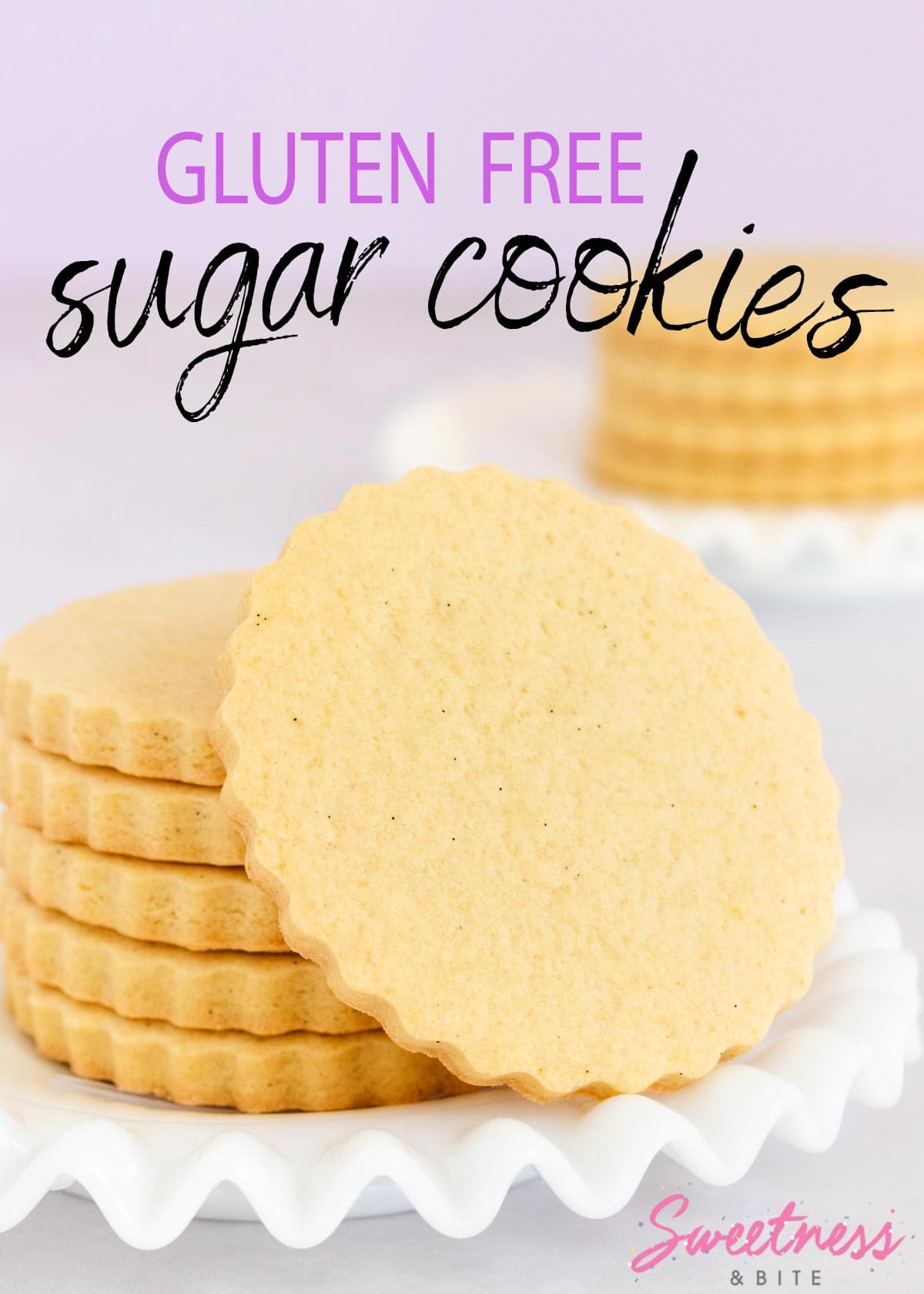 A stack of gluten free sugar cookies on a white glass plate with a ruffled edge. 
