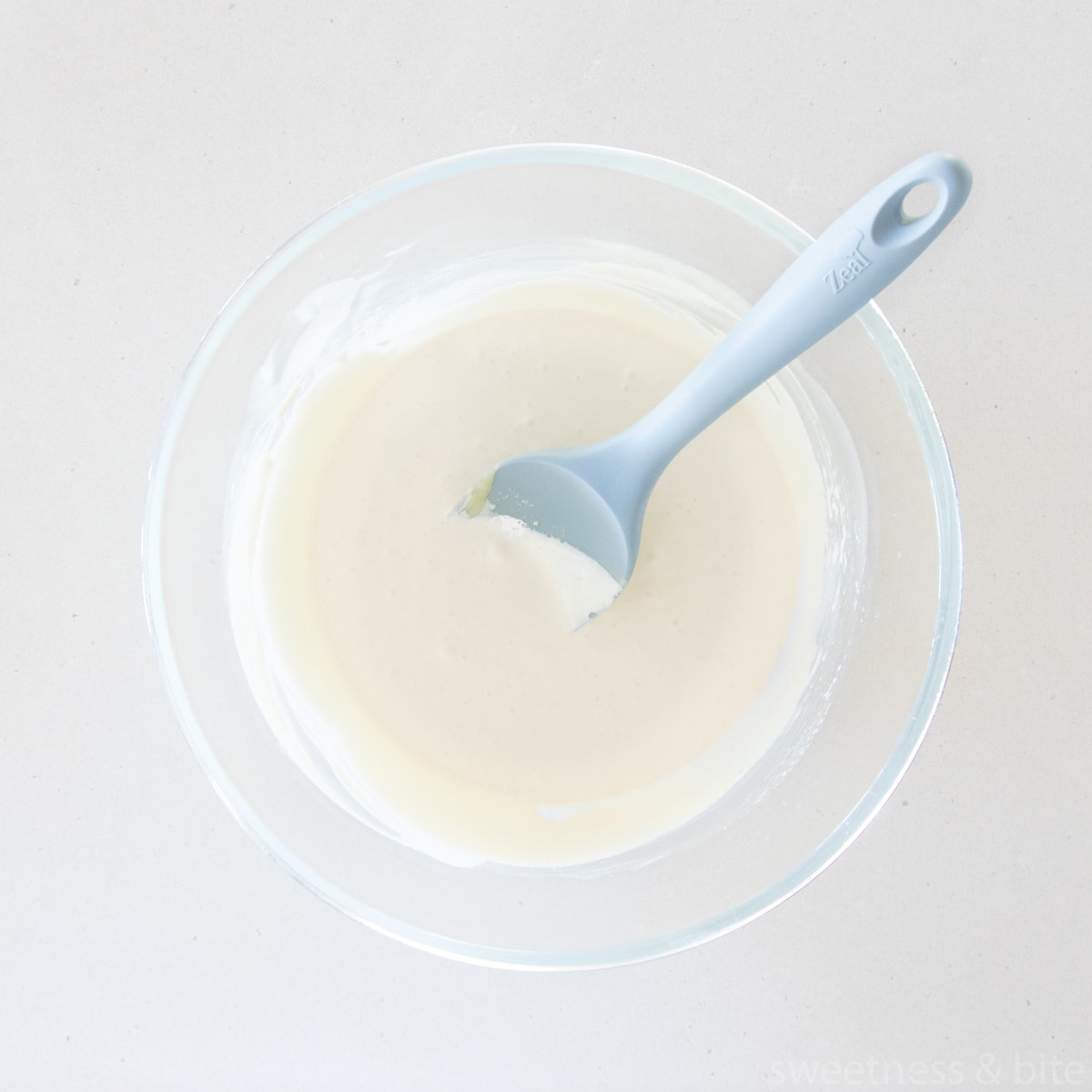 A bowl of white chocolate ganache whitened with white food colouring.