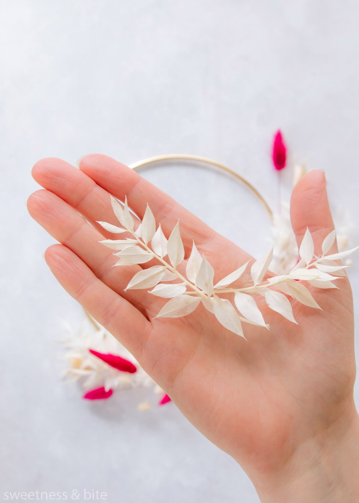 Linking two short pieces of ruscus.