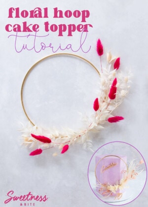 A gold hoop decorated with pink and cream flowers and leaves, text overlay reads 