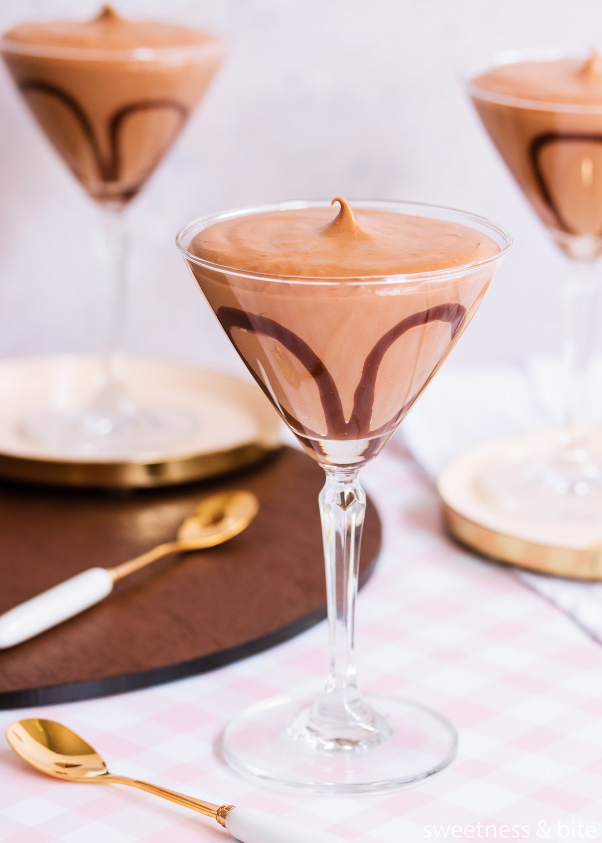 Close up of a glass of mousse showing the ganache decoration.