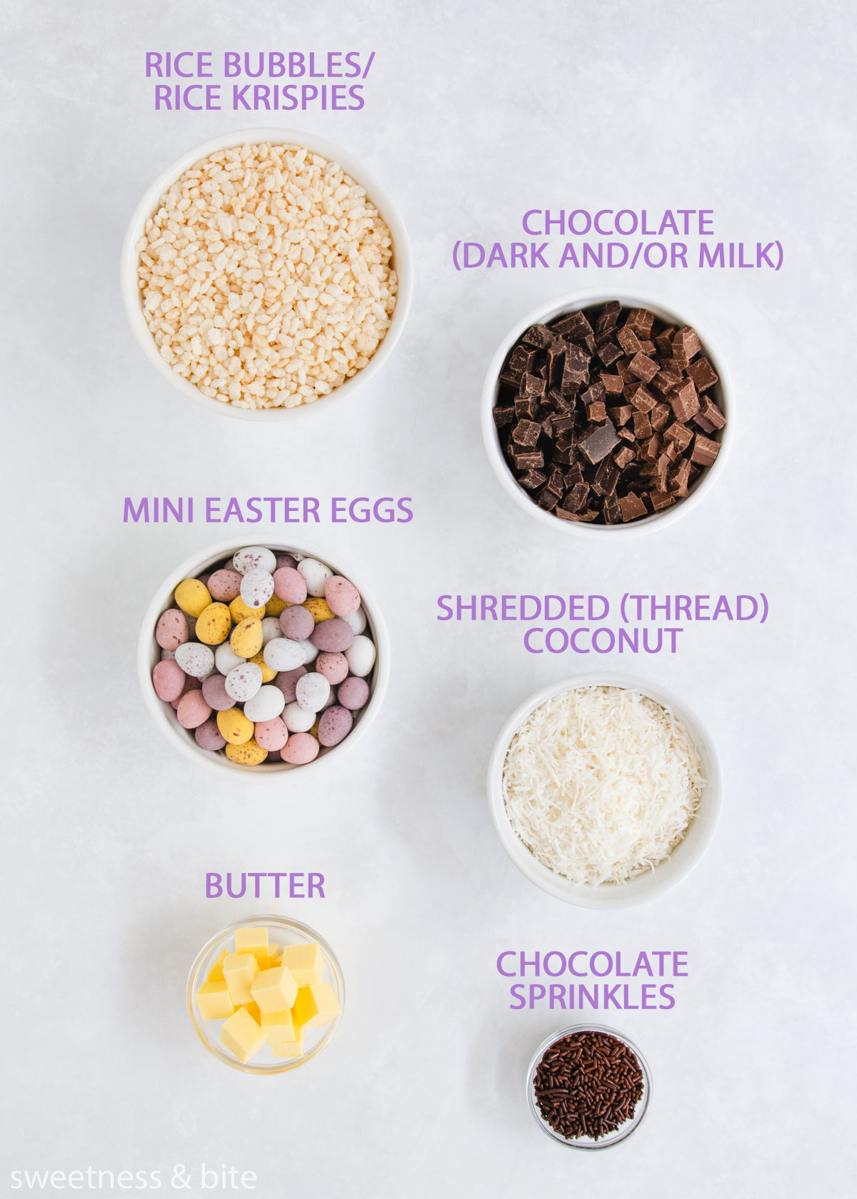 Each of the Easter nest ingredients in white bowls on a grey background.