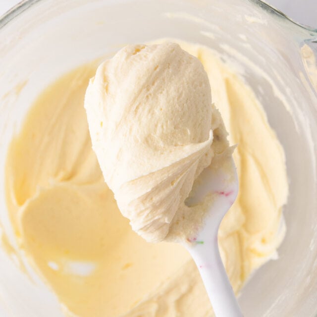 A close up of a spoonful of the cream cheese frosting.