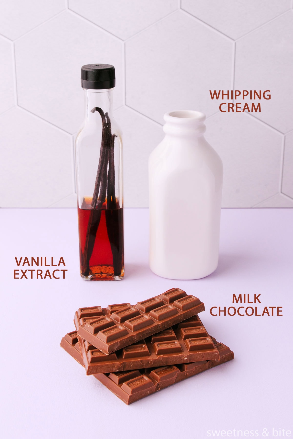 The labelled milk chocolate mousse ingredients - whipping cream, milk chocolate and vanilla extract.