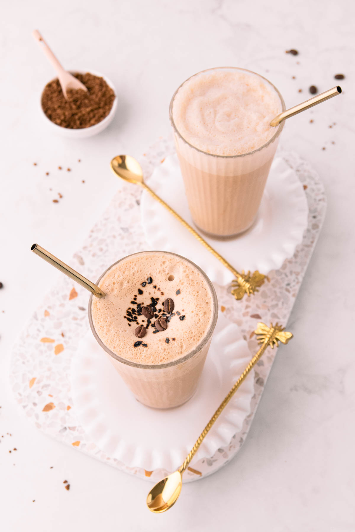 Overhead image of two coffee shakes.