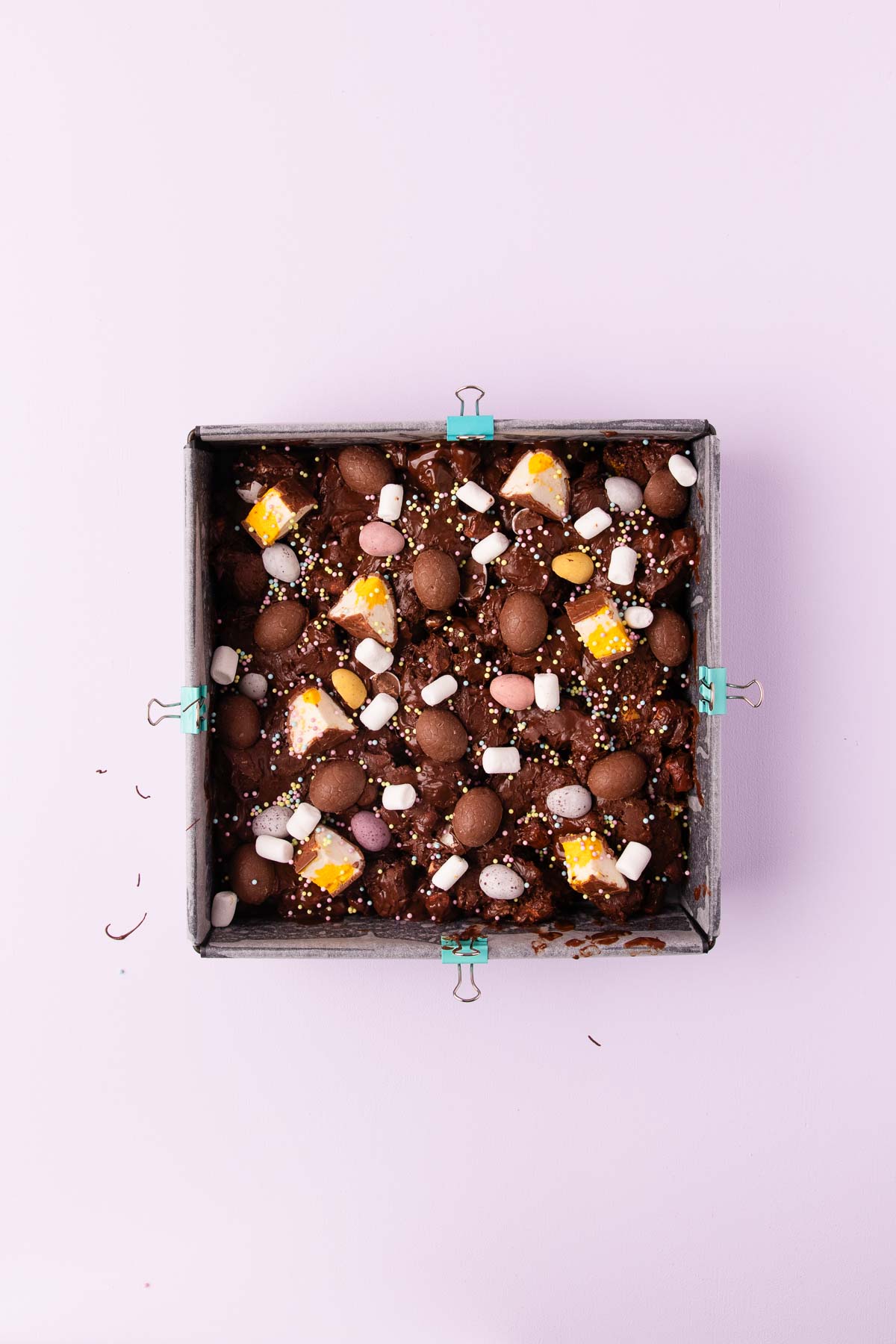 The Easter egg rocky road in a square cake pan lined with baking paper. 
