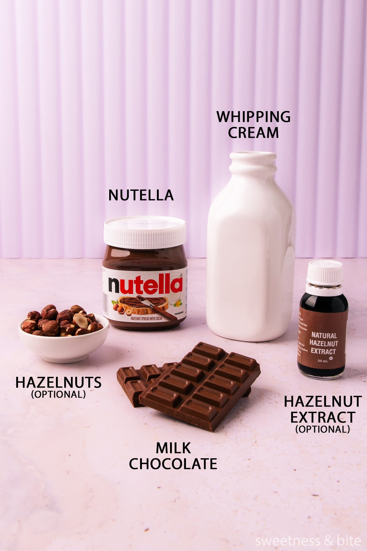 The Nutella mousse ingredients - cream, Nutella, milk chocolate, hazelnut extract and hazelnuts, on a light purple background.