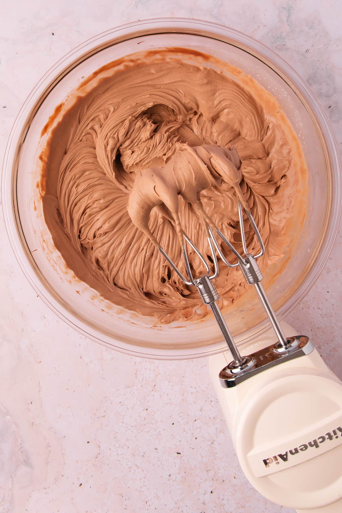 The whipped mixture with a cordless handheld electric mixer.