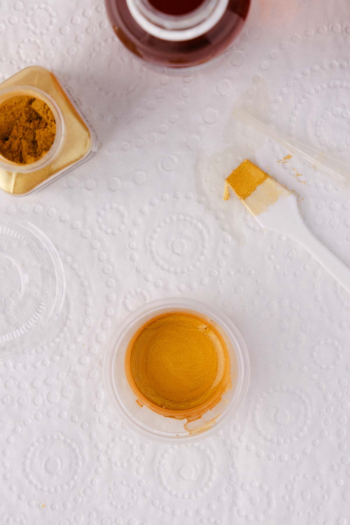 Close up of the container of finished gold paint. 